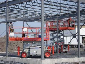 Scissor Lift rentals made by SkyJack elevating workers on construction site