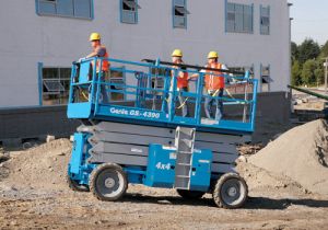 GS-4390 Rough Terrain Scissor Lift moving workers across job site
