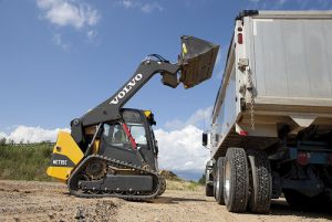 Compact Track Loader loading dirt in dump truck