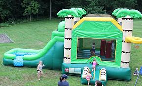Bounce house with slide and rock wall