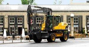 Volvo manufactured wheeled excavator on retail building construction site